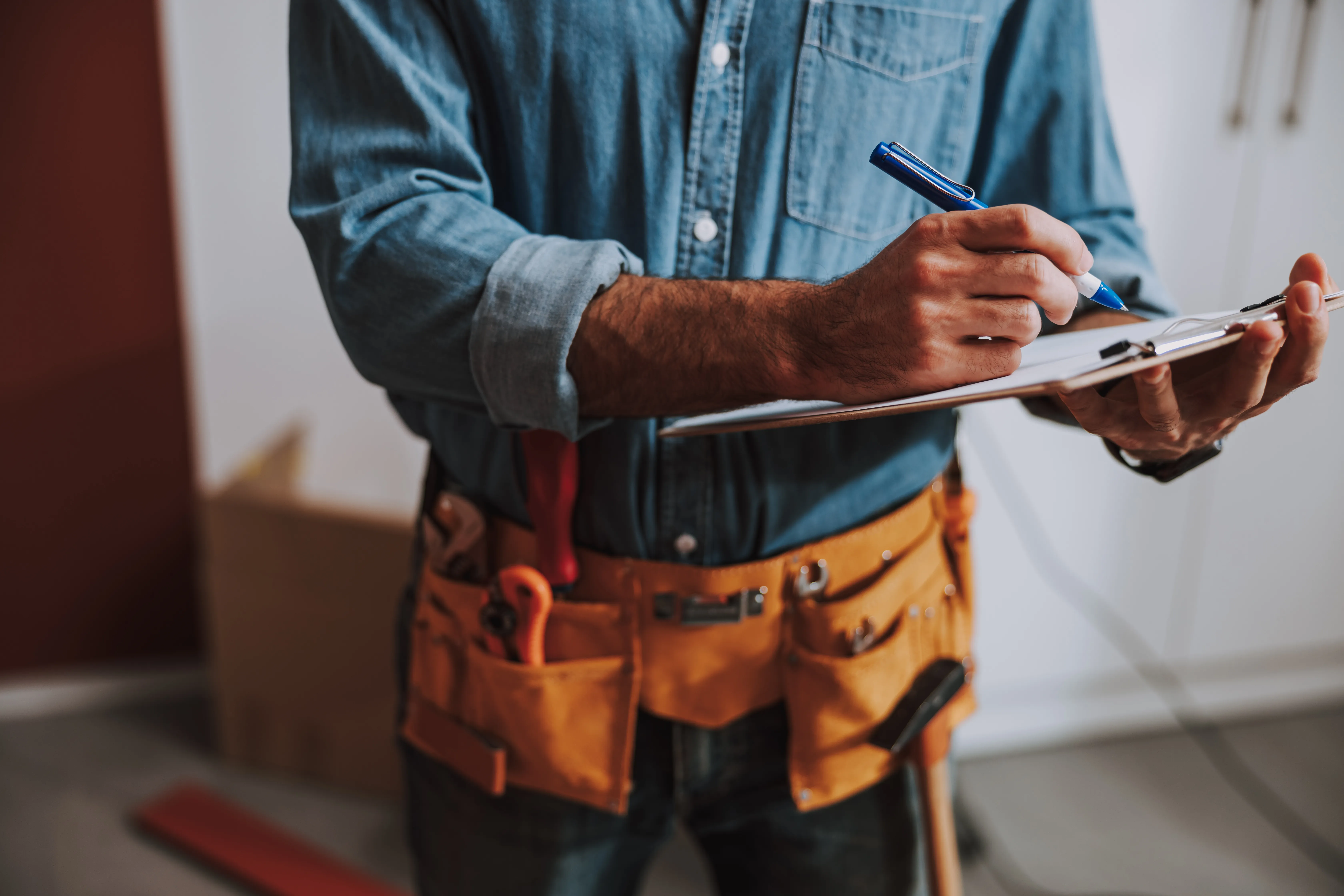 Construction worker writing on clipboard stock photo(1).jpeg